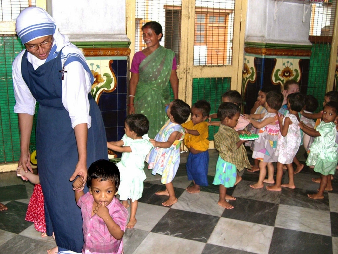 Kalkutta (Indien), 2003: Eine Ordensschwester der "Missionarinnen der Nächstenliebe" spielt im Waisenhaus mit Kindern. Das Haus wurde 1956 von Mutter Teresa gegründet. Im Jahr 2003 wurden dort über 300 Kinder betreut.