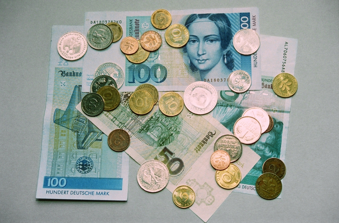 Bis 2001 war die Deutsche Mark die offizielle Währung in Deutschland. Hier sieht man DM-Münzen und verschiedene Geldscheine.