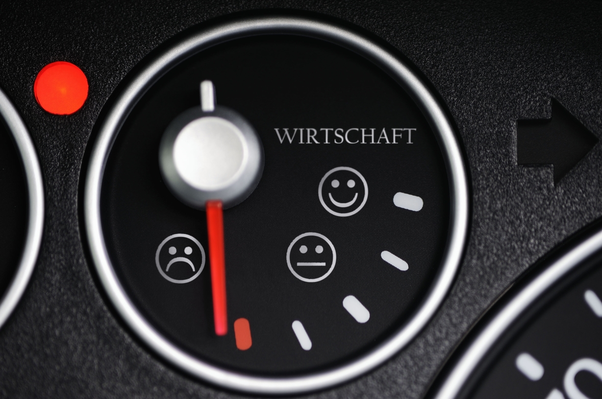 Ein Tachometer zeigt mit Smileys an, dass es immer weniger freundlich wird, je mehr die Wirtschaftskraft abnimmt.