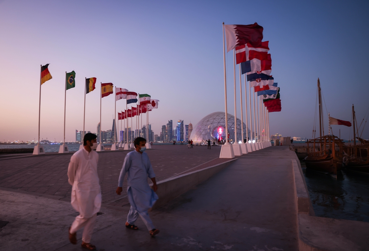 Flaggen der verschiedenen Teilnehmer-Nationen der WM 2022 sind in Doha zu sehen. Dahinter erkennt man die Skyline der Hauptstadt.