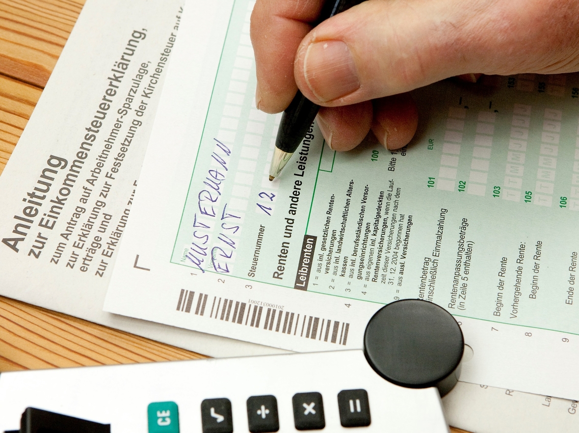 Eine Person füllt ein Formular für die Steuererklärung aus.