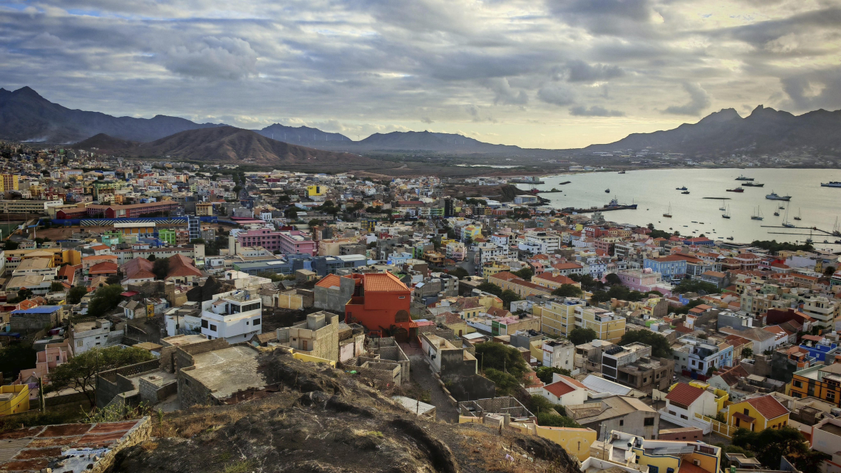 Panoramablick über die Stadt Mindelo mit Bergen und Meer und bunten Häusern.