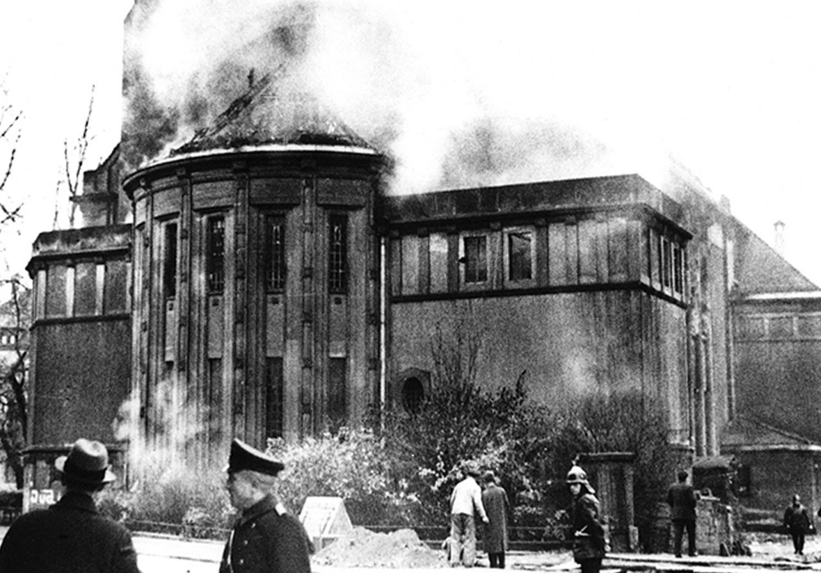 Feuerwehrleute stehen am 9. November 1938 vor der brennenden Synagoge in Bamberg, die bei Ausschreitungen gegen Juden und jüdische Einrichtungen angezündet wurde.