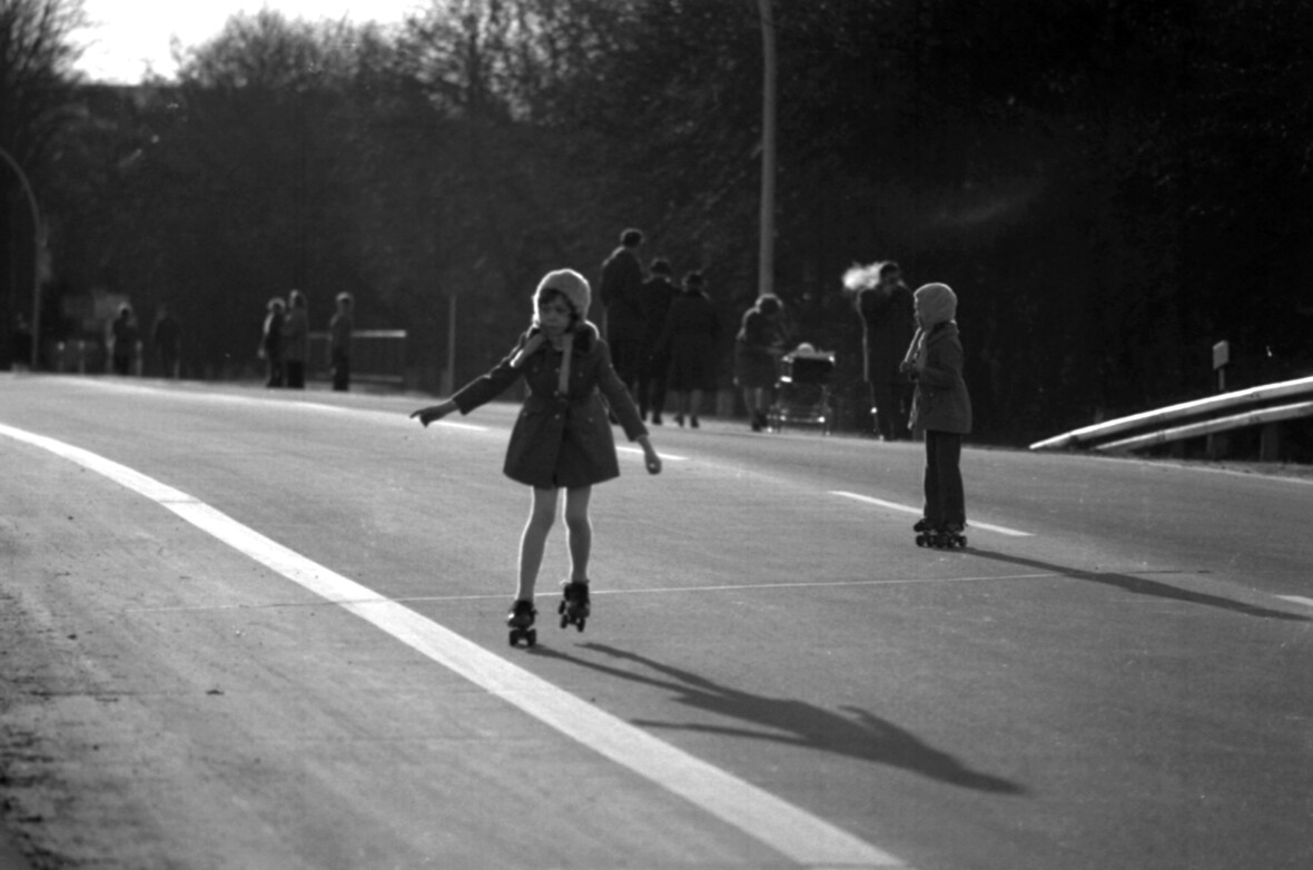Kinder fahren  am autofreien Sonntag auf der Autobahn Rollschuhe.