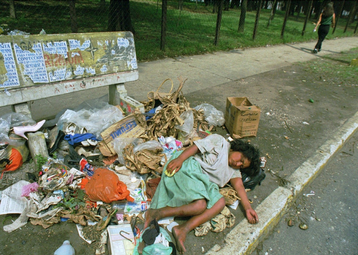Eine obdachlose Frau in Guatemala schläft im Müll