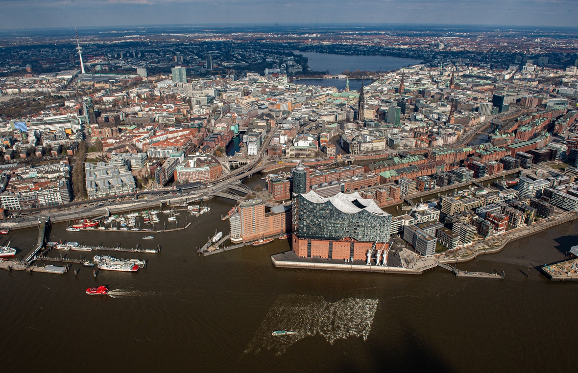 Das Luftbild zeigt die Elbphilharmonie im Hamburger Hafen, die Speicherstadt, das hochmoderne Wohnviertel Hafencity, das Rathaus und im Hintergrund die Alster.