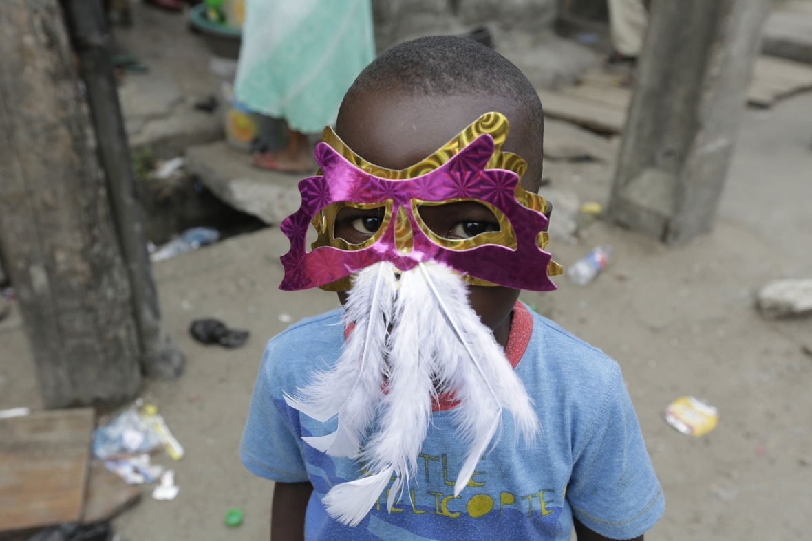 Auch in der nigerianischen Hauptstadt Lagos feiern Kinder und Erwachsene Karneval. Dieser Junge trägt eine Gesichtsmaske mit Federn.